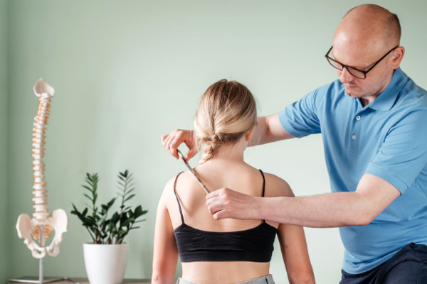 Osteopath providing hands-on soft tissue treatment