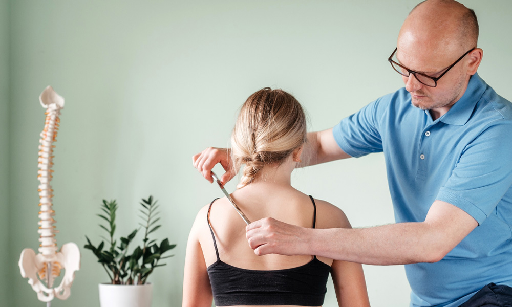 Osteopath providing assisted soft tissue mobilisation