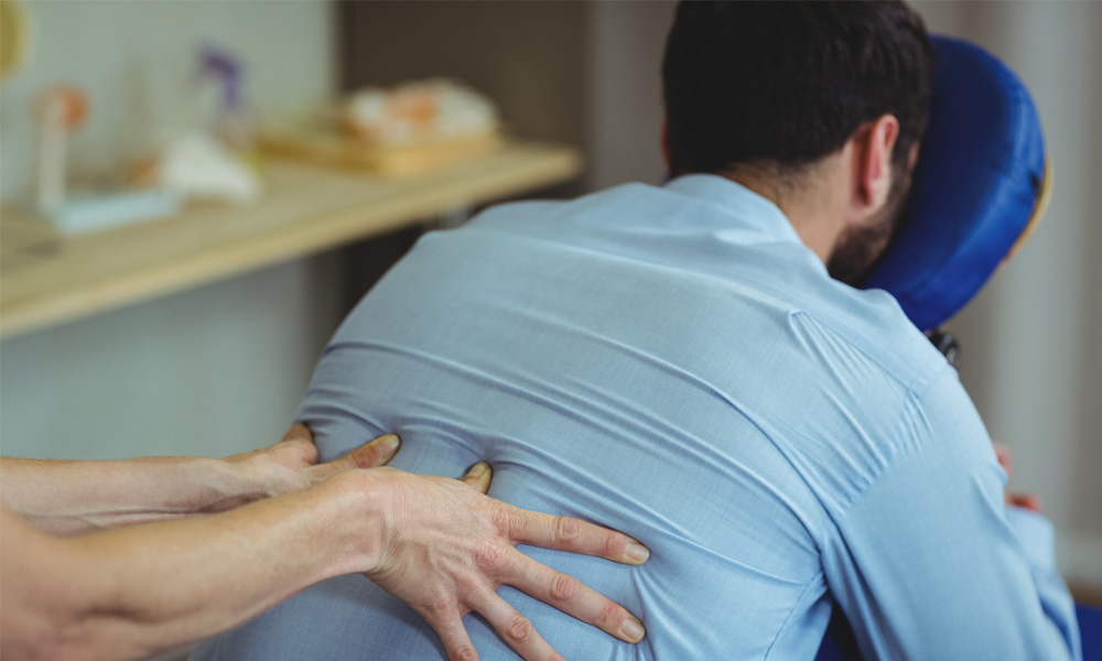 Osteopath treating back pain with hands-on care